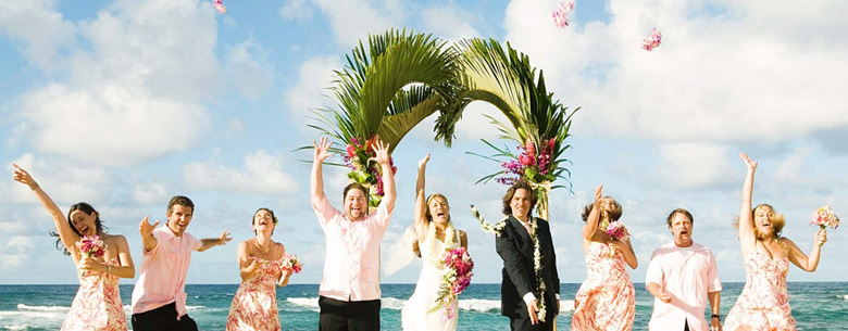 bridal party throwing leis in the air at beach wedding, cameron and deelia photography