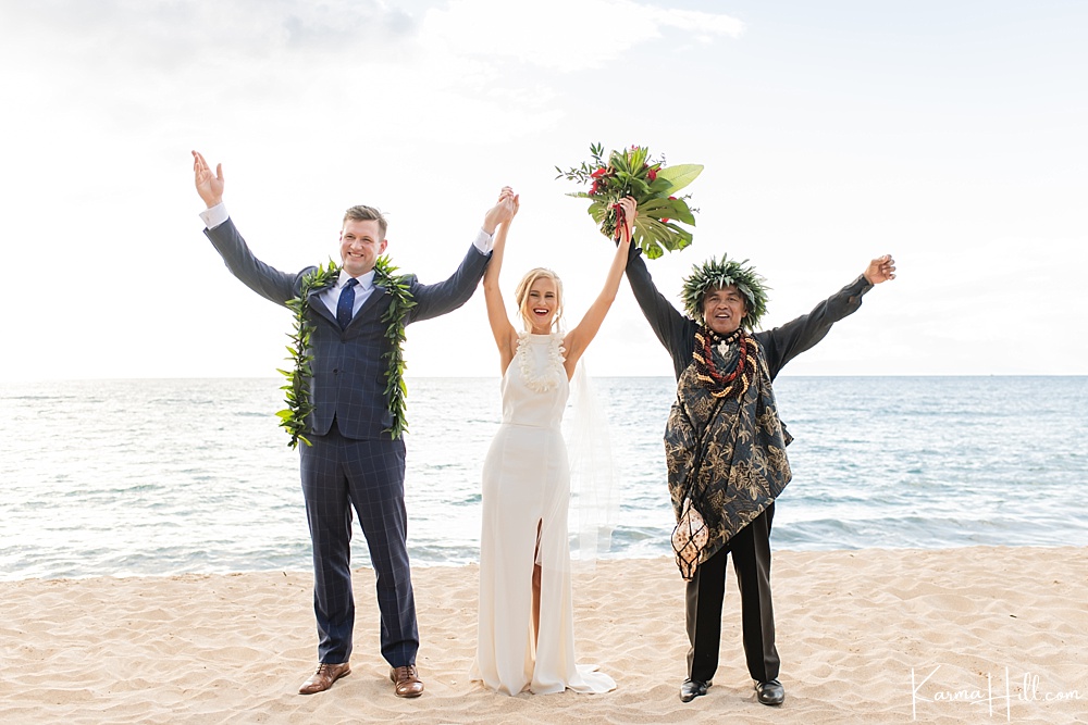 Beach wedding with minister and bride and groom